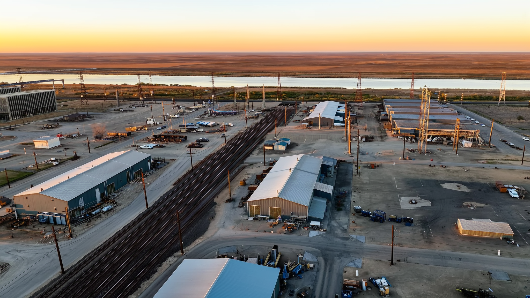 Aerial view of an industrial site with utility substation and transmission lines
